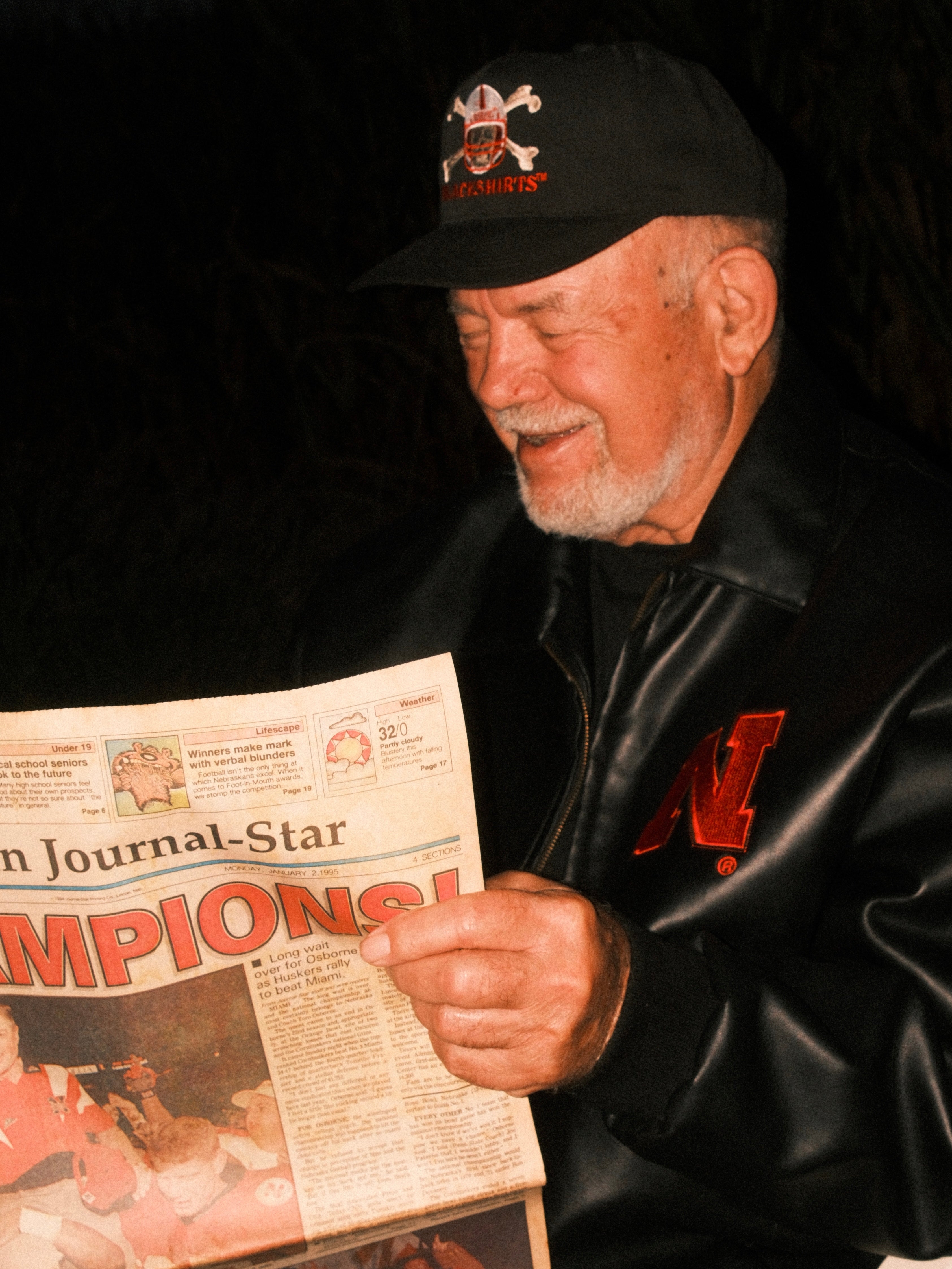 Man reads 1995 National Championship Newspaper
