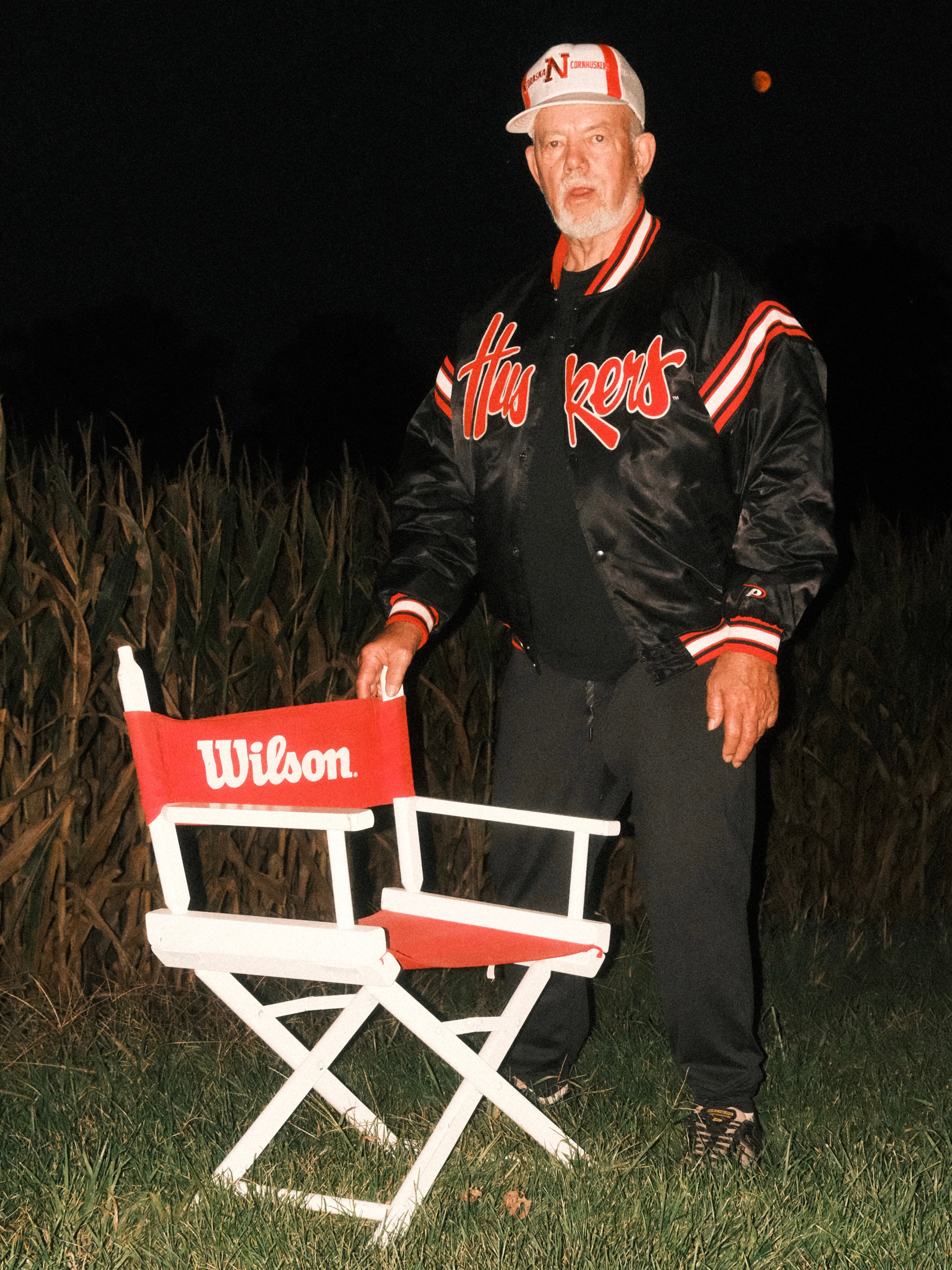 Man poses with vintage Wilson director chair