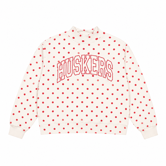 WhiteNebraska Huskers mockneck sweatshirt with red polka dots and outlined arched HUSKERS lettering on a white background.