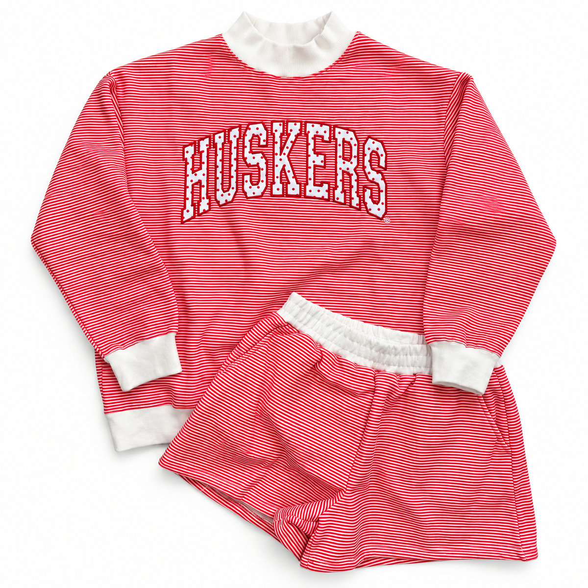 Nebraska Huskers red and white striped mockneck sweatshirt and matching shorts set with white trim and arched Huskers lettering.