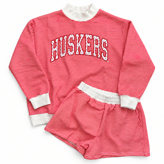 Nebraska Huskers red and white striped mockneck sweatshirt and matching shorts set with white trim and arched Huskers lettering.