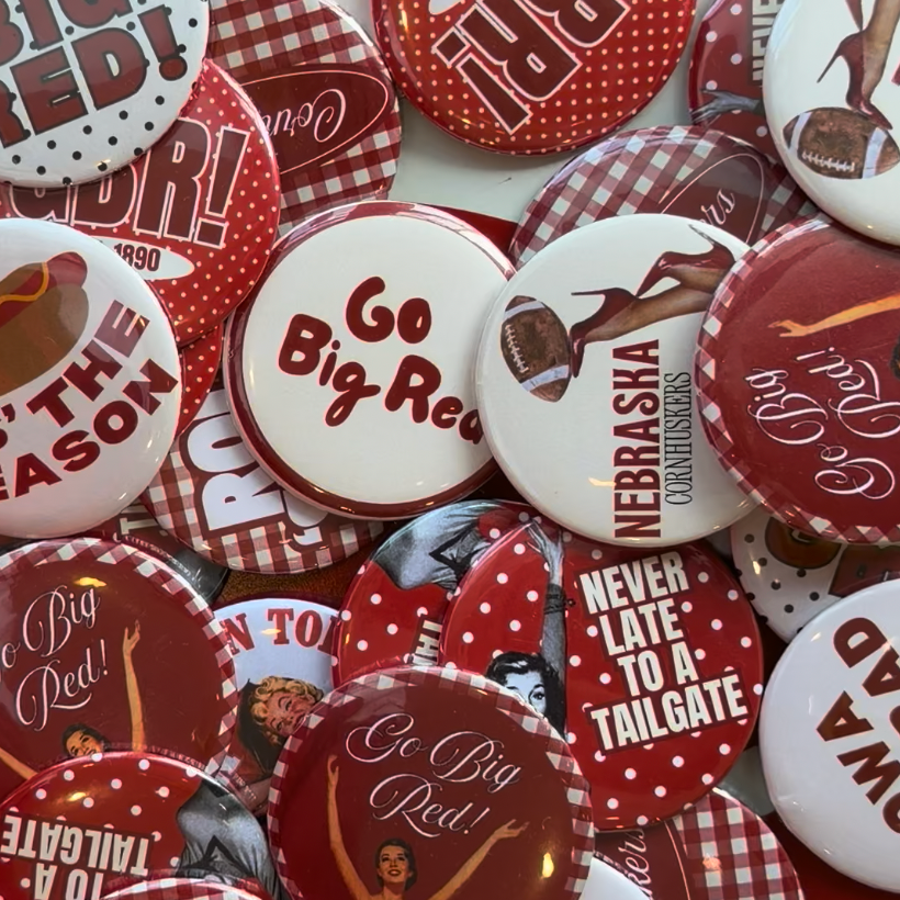 Mixed assortment of red and white Nebraska-inspired Vintage Cowboy pinback buttons