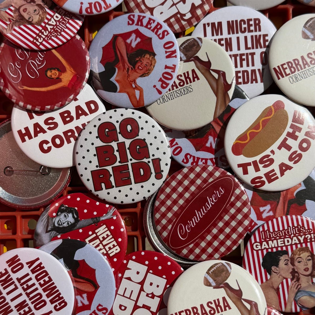Assorted Nebraska-inspired Vintage Cowboy pinback buttons in red, white, and cream designs