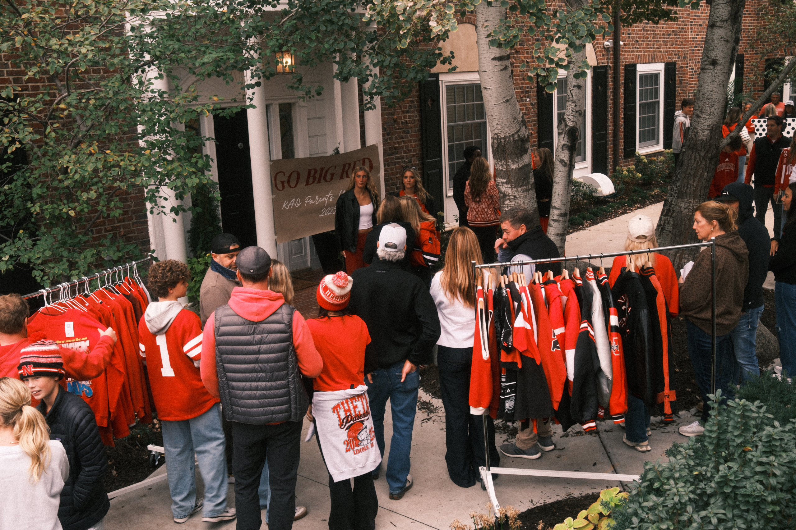 Vintage Cowboy Nebraska clothing pop-up with vintage Huskers apparel displayed outside a campus house