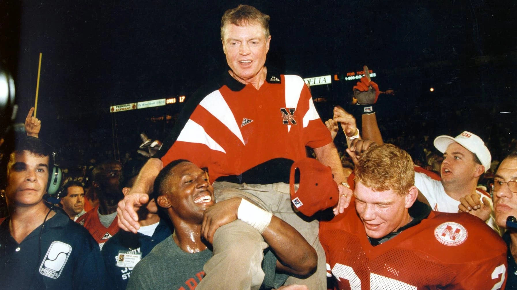 Vintage photo of Tom Osborne celebrating with Nebraska Cornhuskers football players