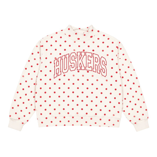 White Nebraska Huskers mockneck sweatshirt with red polka dots and outlined HUSKERS lettering